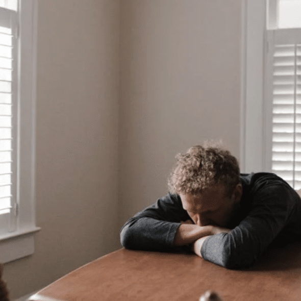 A man looking sad at home