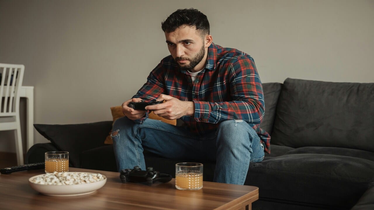 A man sad while playing video games.