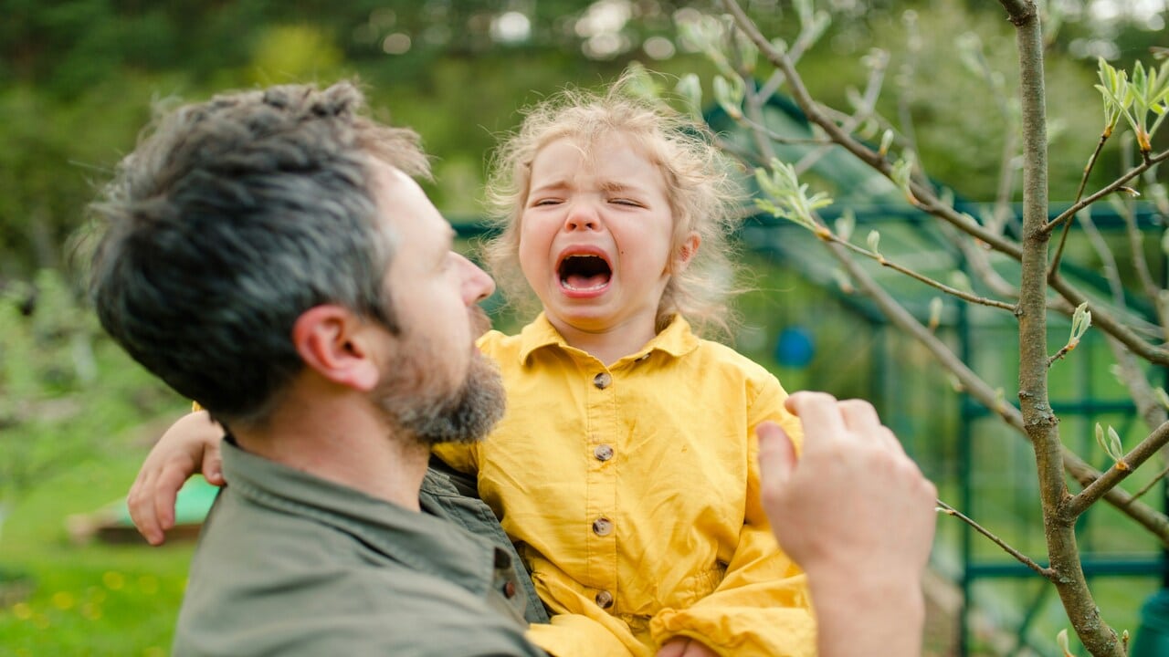 A dad comforting his daughter.