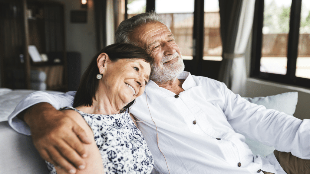 A mature couple sharing earbuds