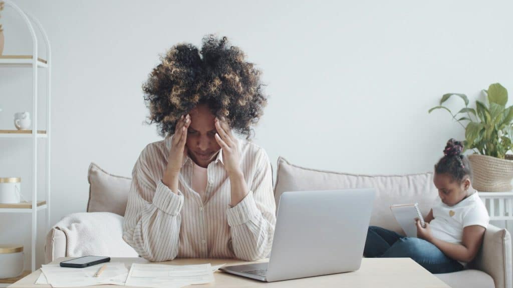 A woman looking stressed at home