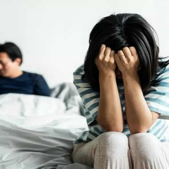 A woman looking sad with her husband