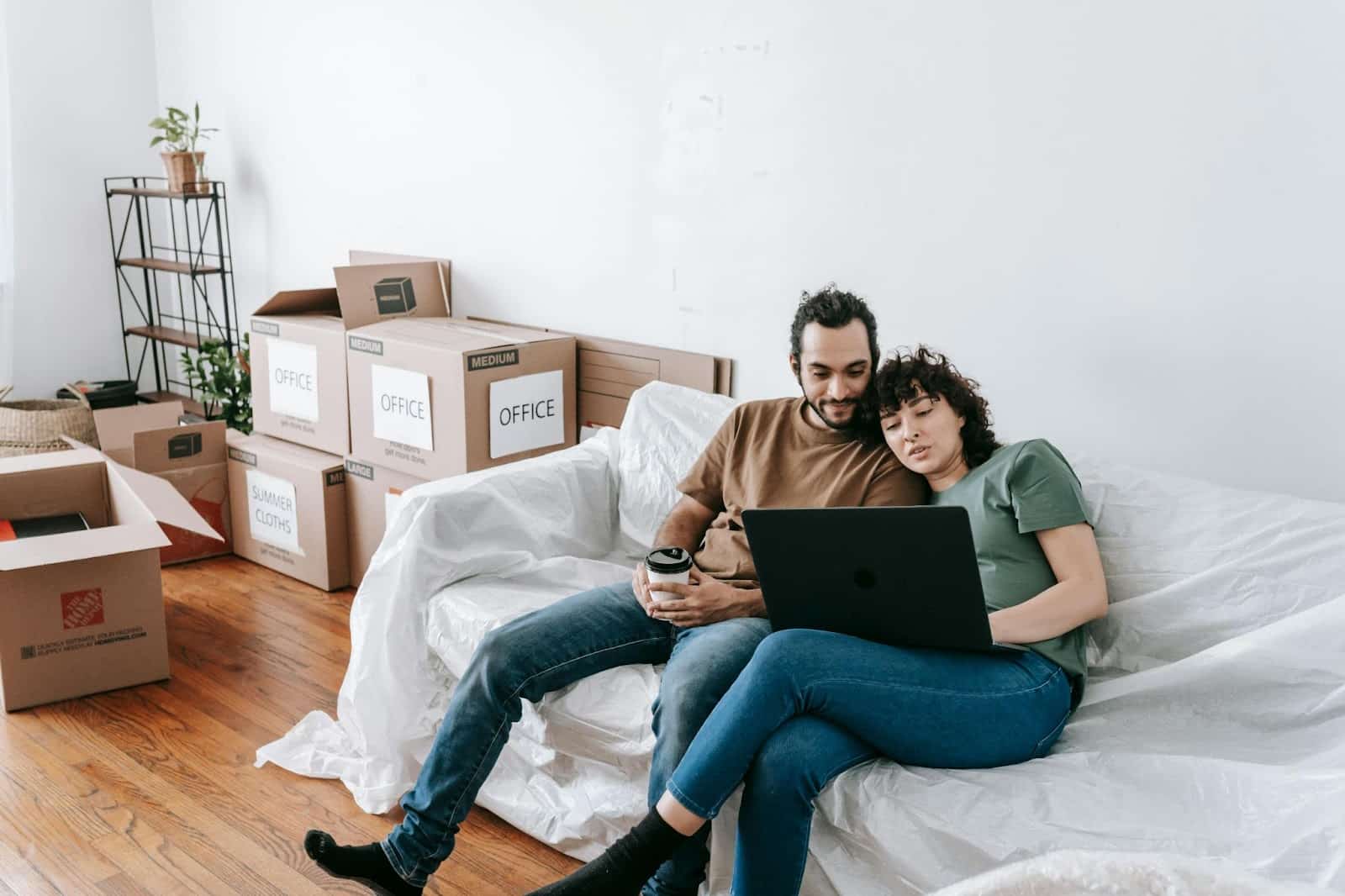 A woman saying something to a man while watching.