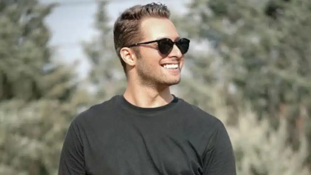 Confident man walking outdoors with relaxed posture and natural smile
