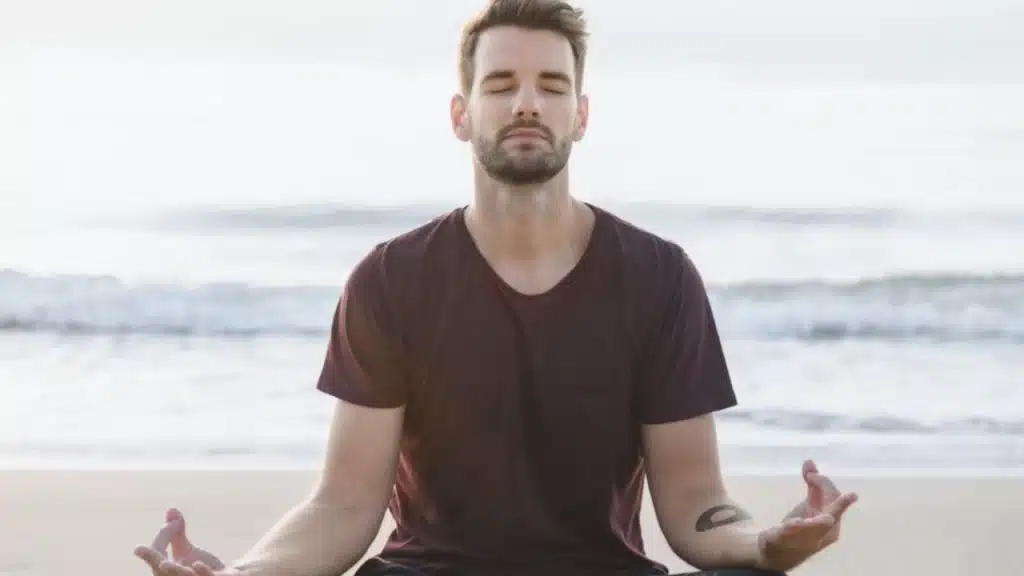 Man practicing meditation outdoors