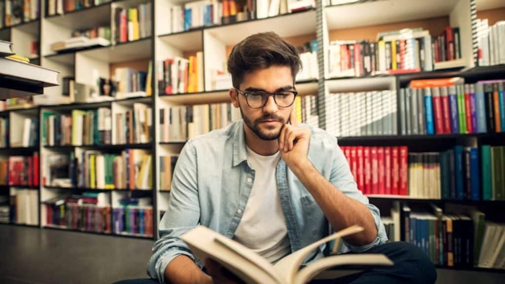 Man reading his journal in the library