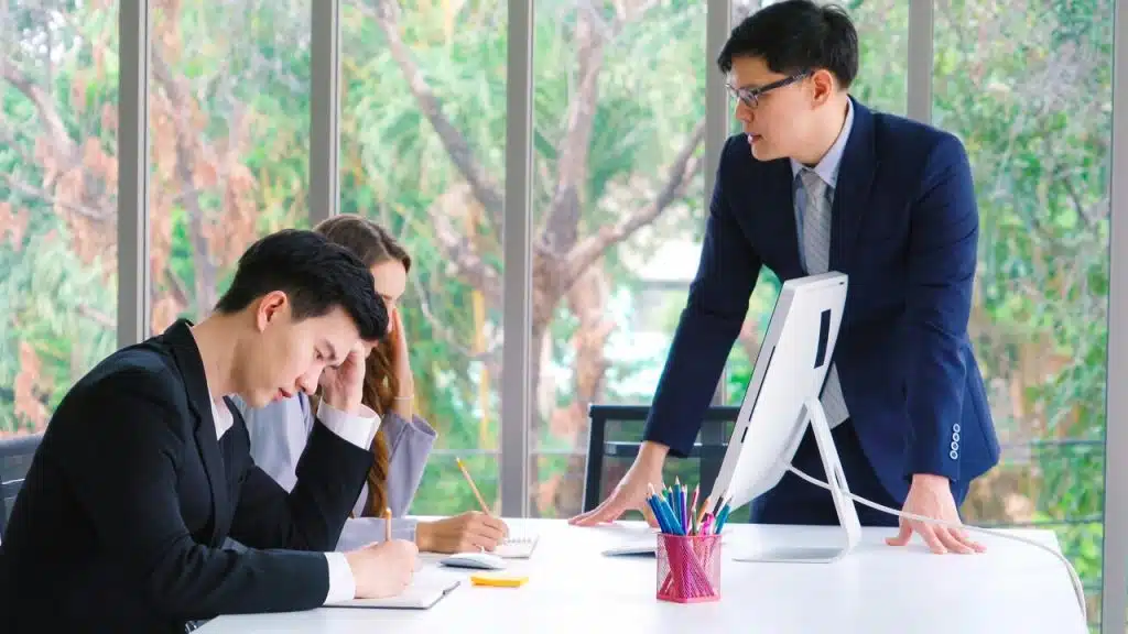 A man blaming his colleagues during a meeting