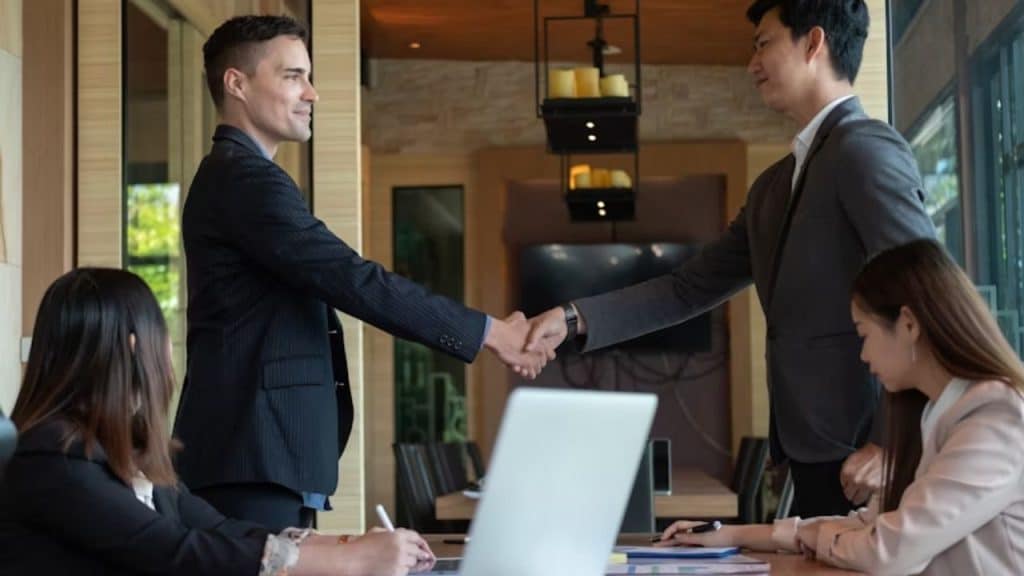 Man smiling after a handshake, walking away from an interview