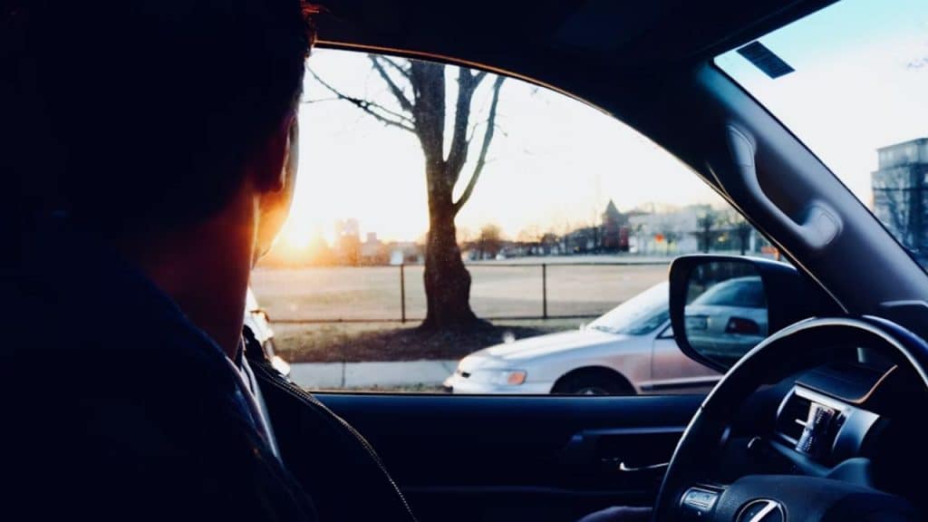 Man allowing another car to merge on a busy street