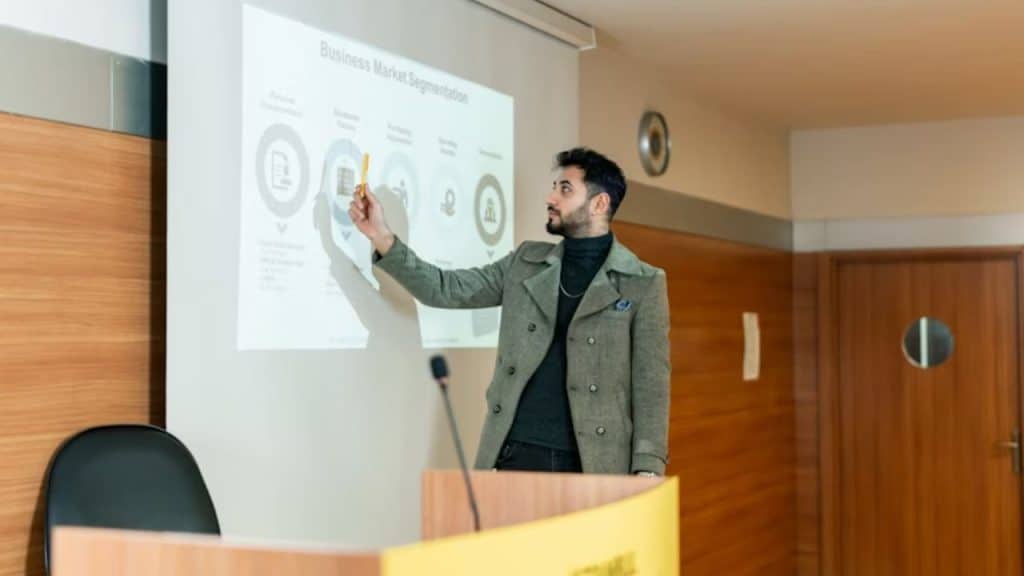 Man giving credit to his colleague during a presentation