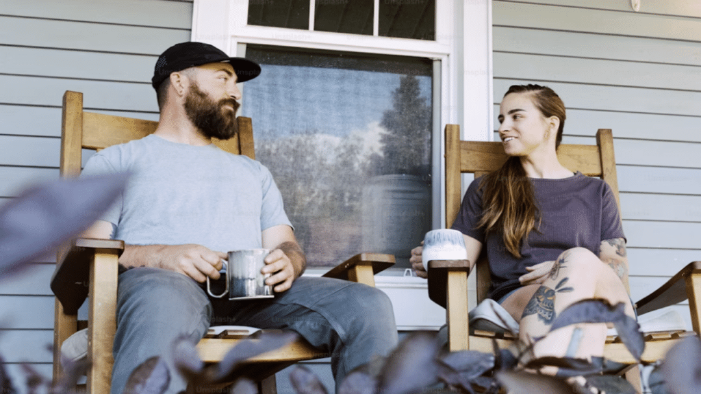A couple talking on the porch