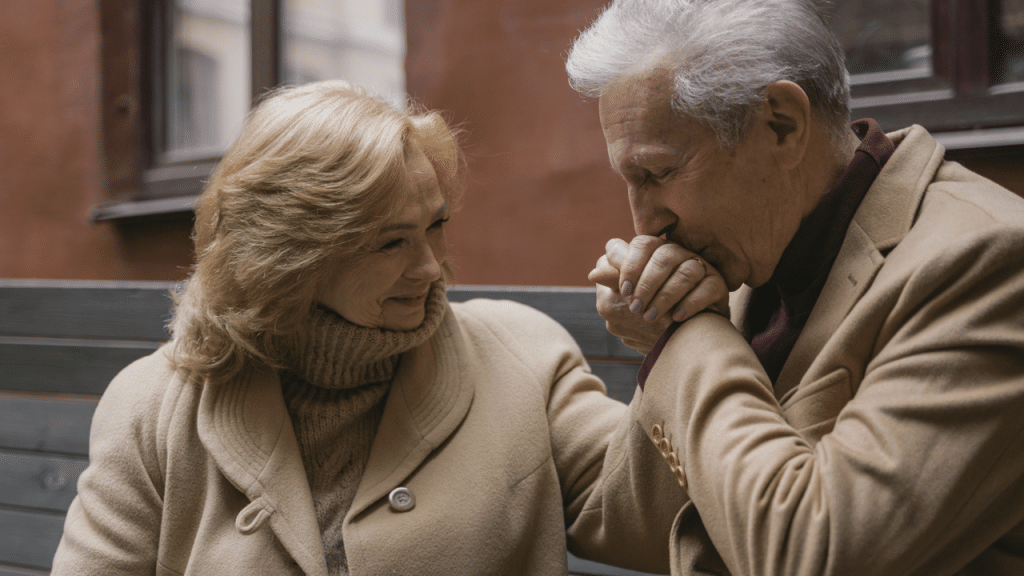 A man kissing his wife’s hand