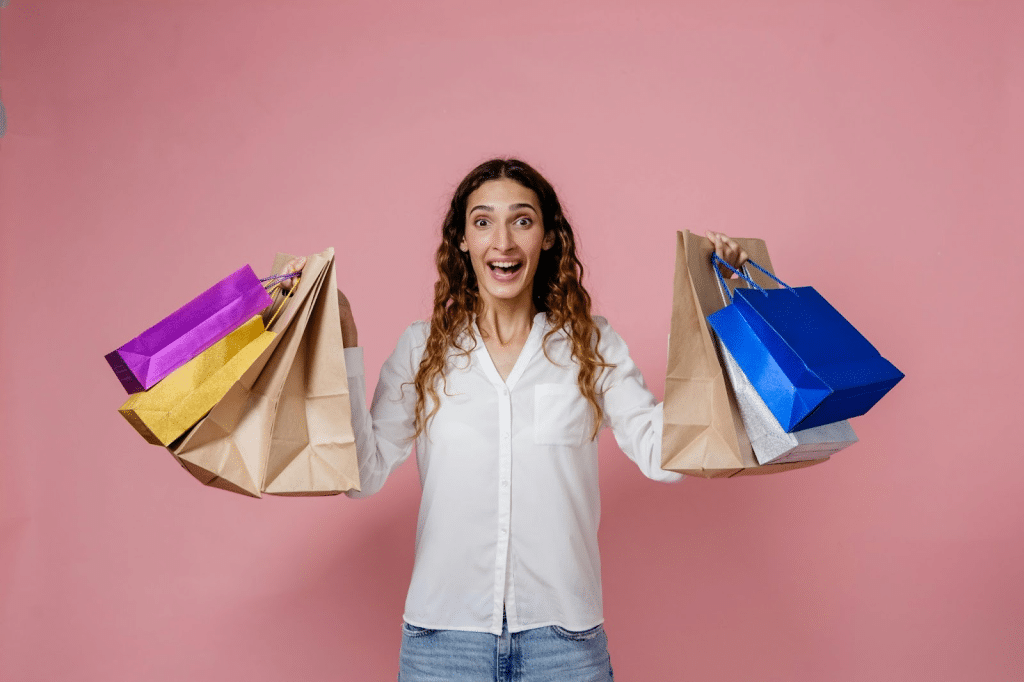 A woman holding a lot of paperbag