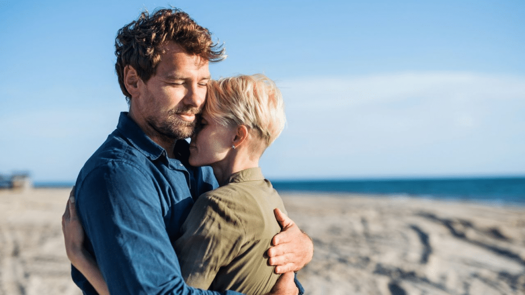 A couple hugging at the beach.