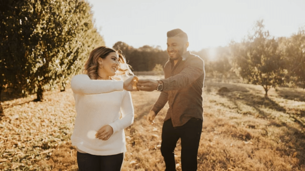 A couple laughing together after a proposal moment