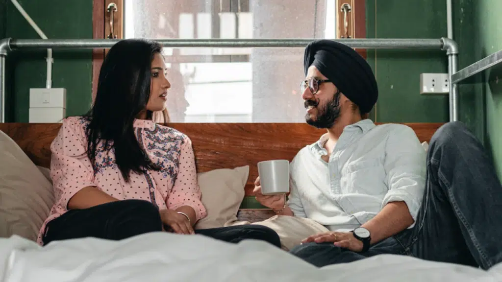 A couple talking and resting in bed