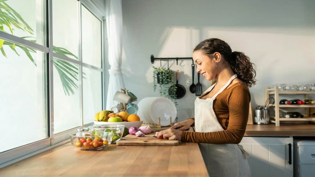 A woman smiling while cooking