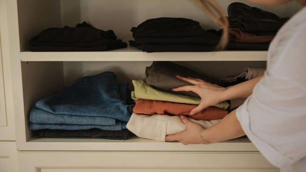 A woman taking some clothes from the closet