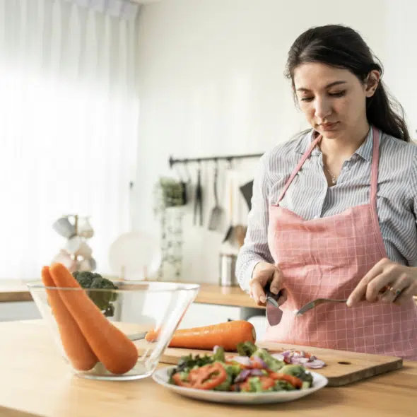 A woman looking serious while cooking