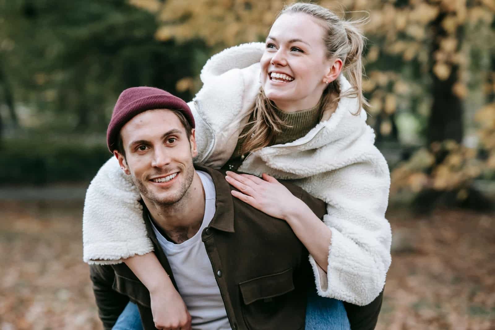 A man carrying a woman on his back.