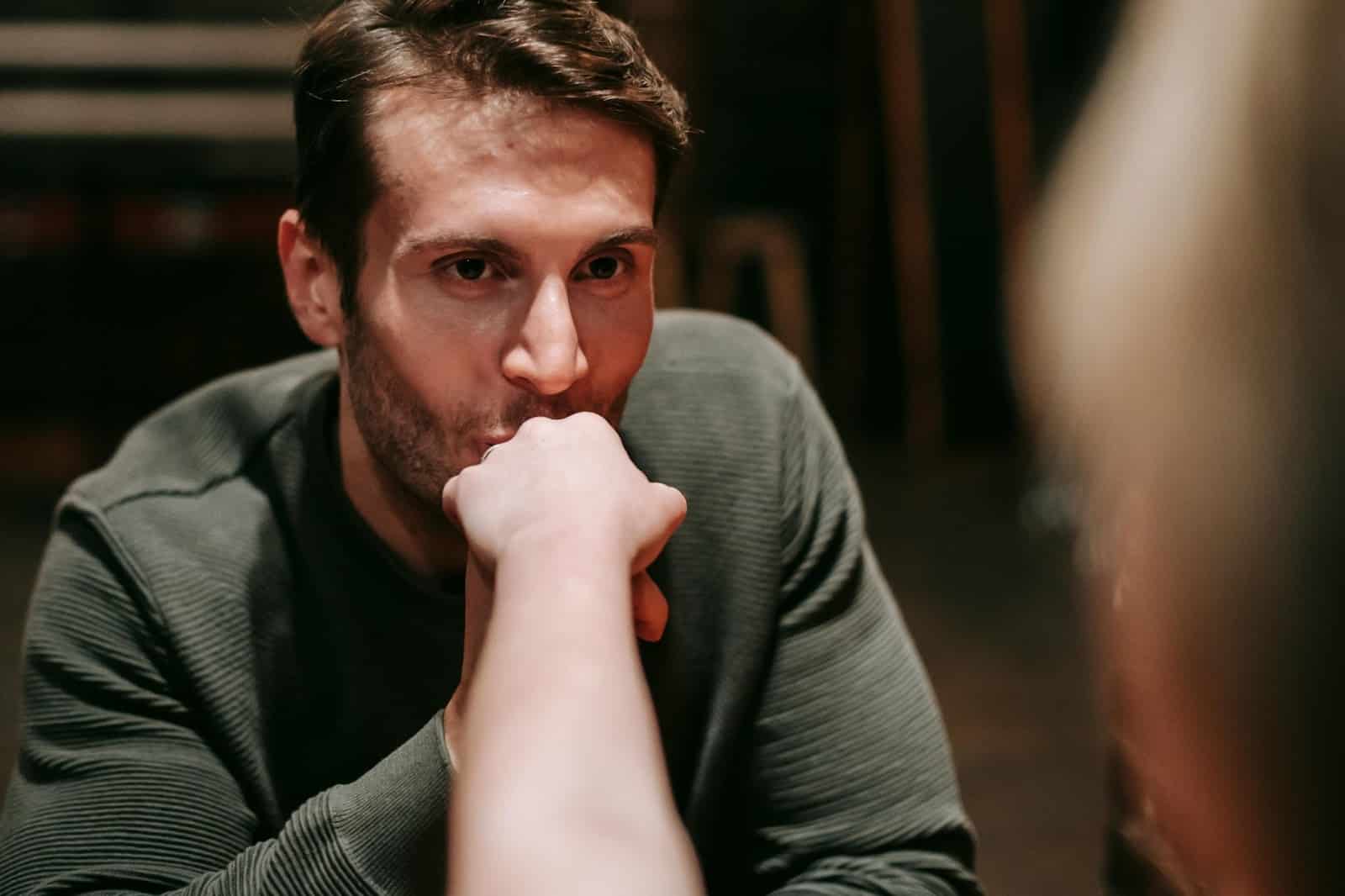 A man kissing a woman’s hand.