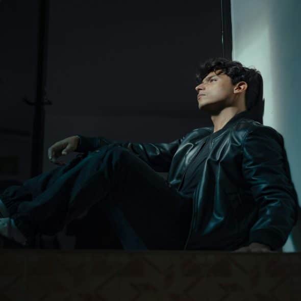 A man looking sad in a dark room