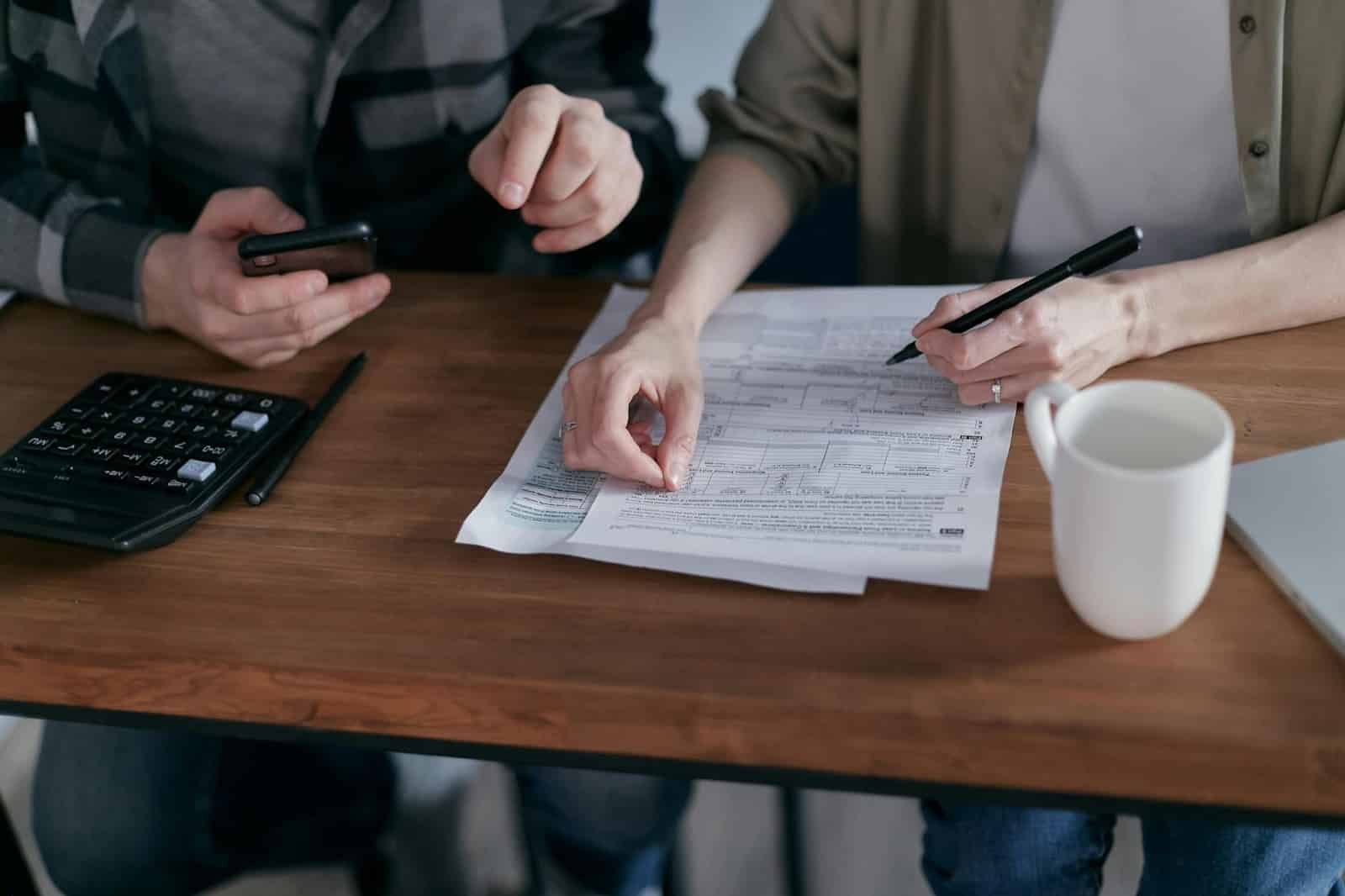 A man and woman checking their bills.