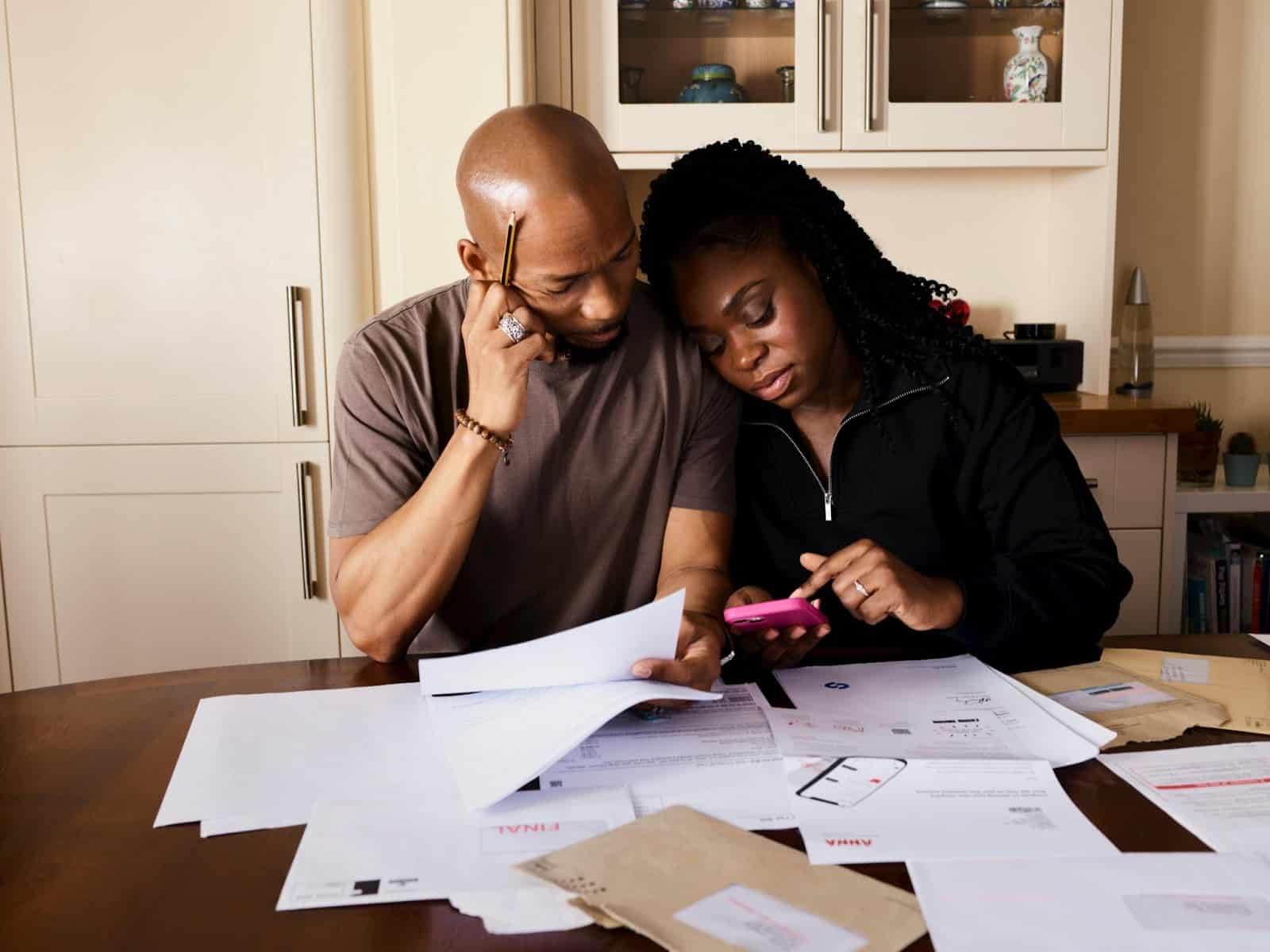 A man and woman having problem with their bills.
