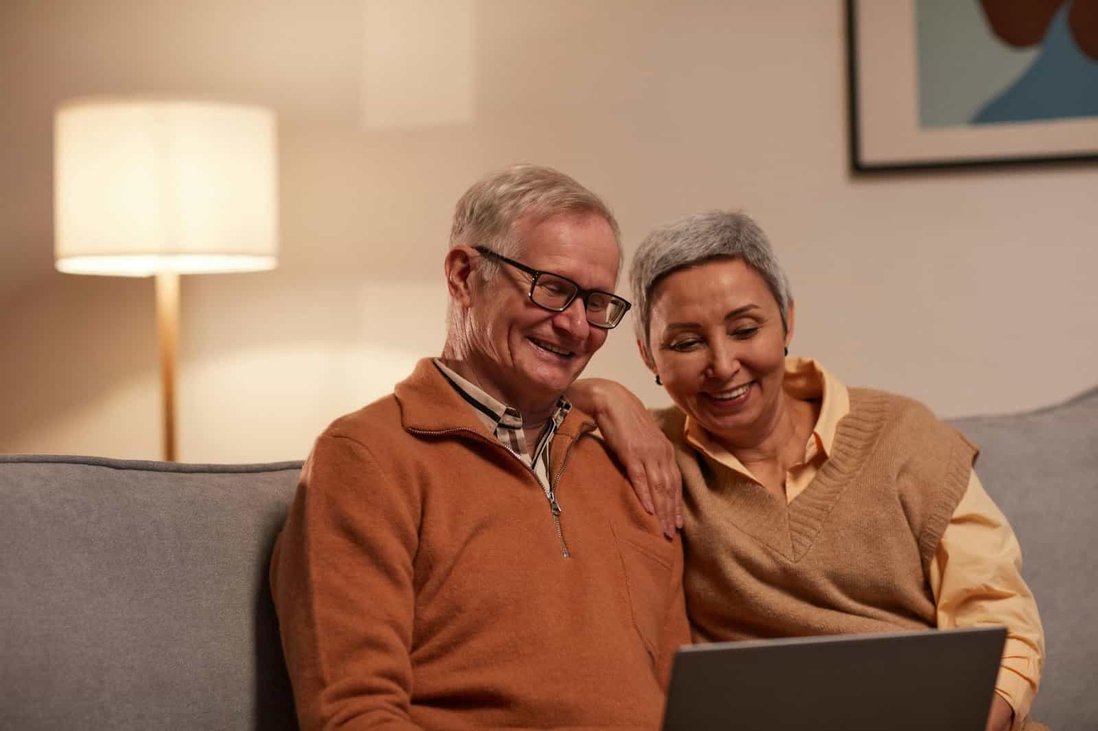 A man and woman using a laptop.