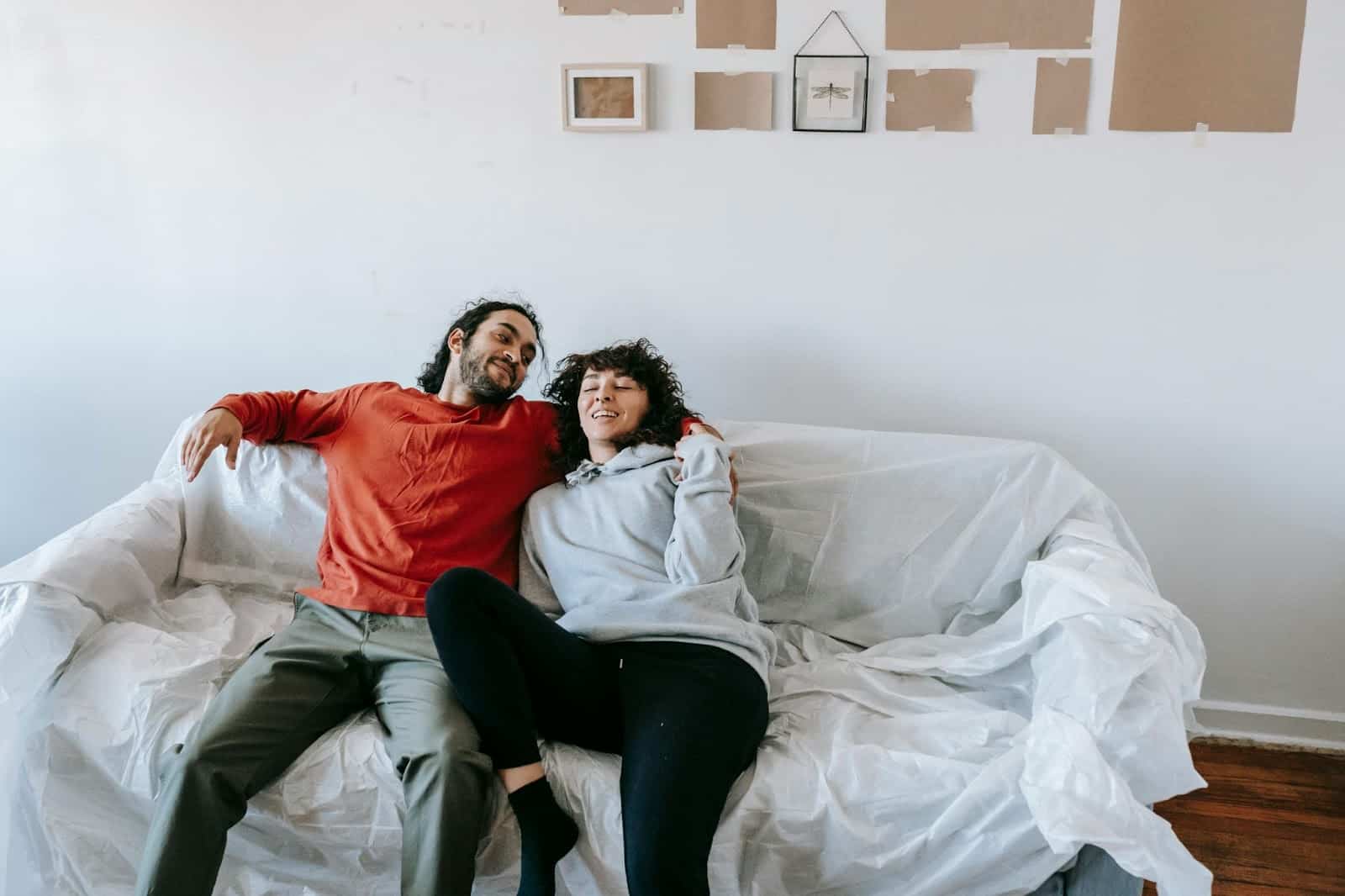 A man and woman sitting at the couch
