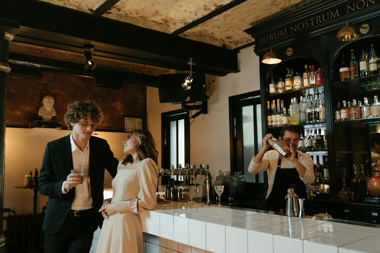 A man and woman standing beside the bar.