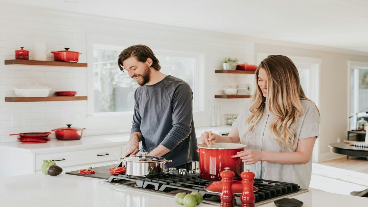 A couple cooking in the kitchen.