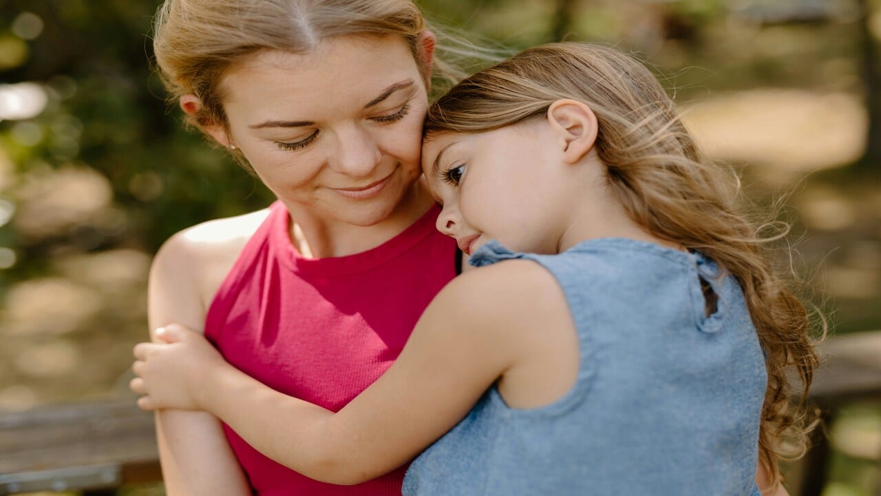 A woman hugging her daughter.