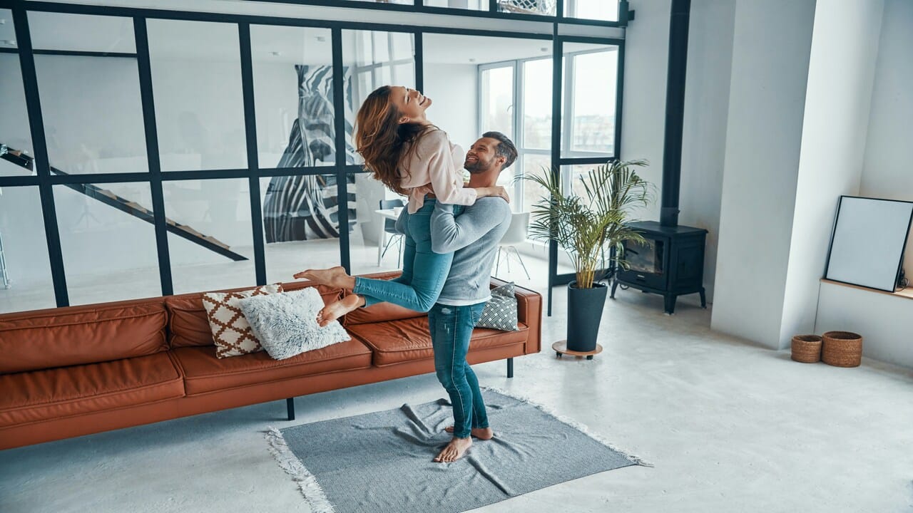 A couple hugging in the living room.