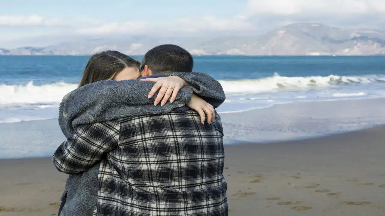 A couple hugging after a fight.