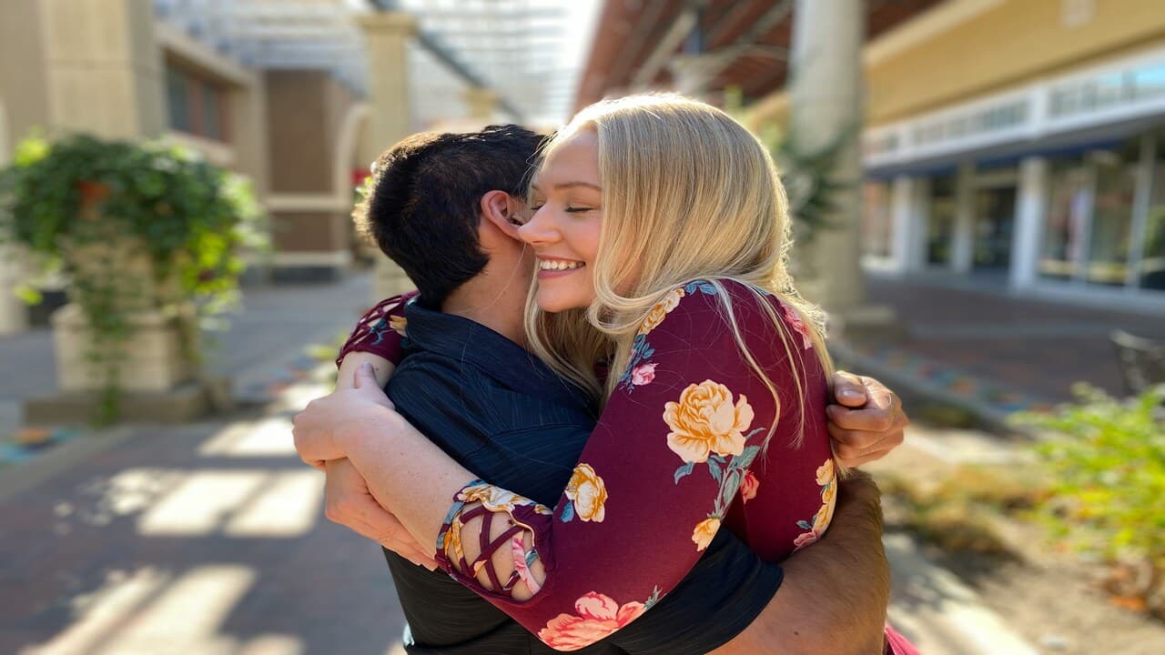 A couple hugging outdoors.