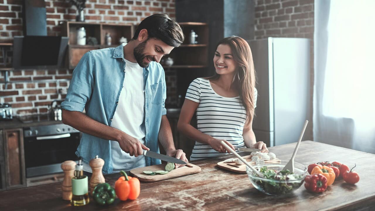A couple cooking together.