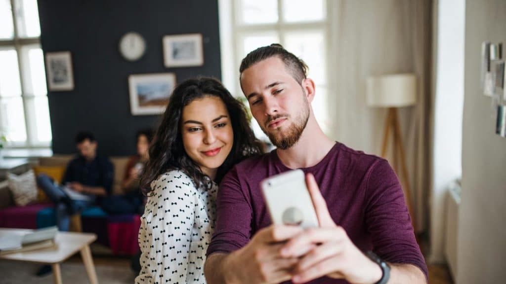 A couple taking a selfie together indoors.