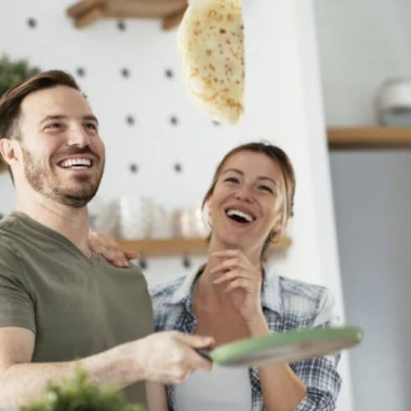 Man making breakfast with his wife.