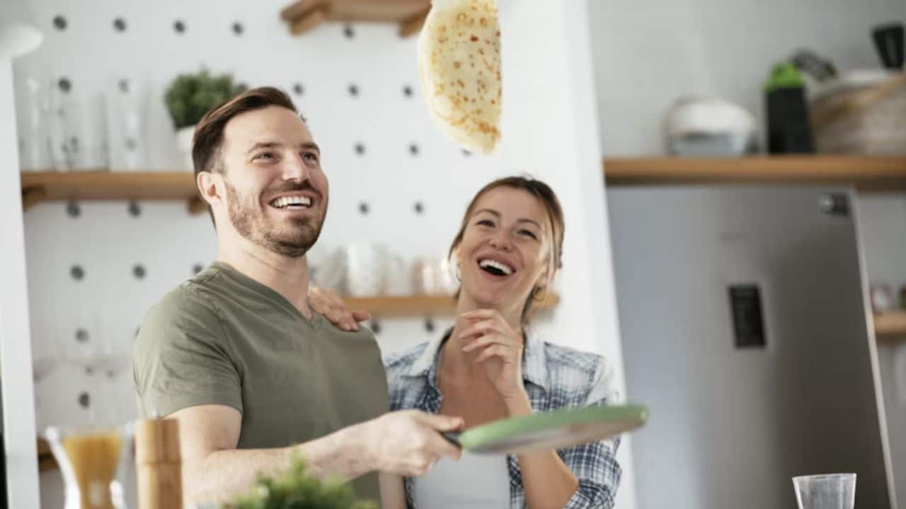 Man making breakfast with his wife.