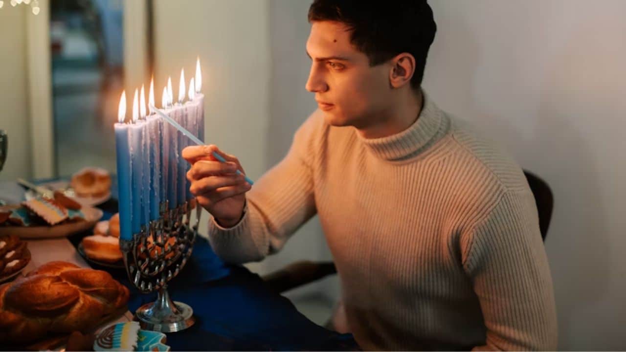 Husband lighting candles for an at home dinner date.