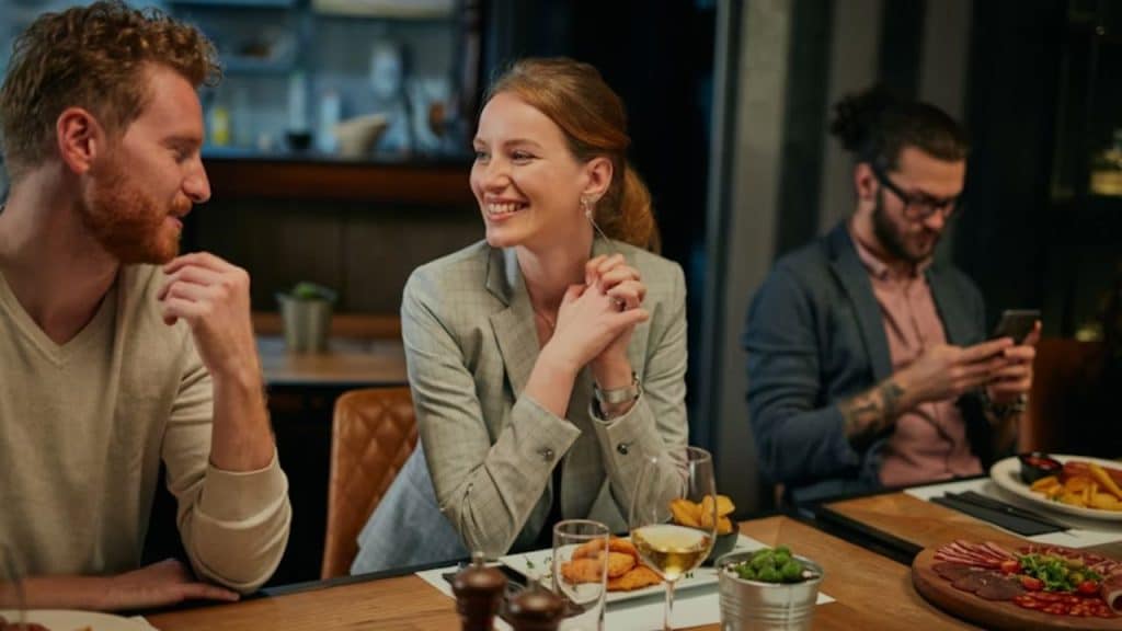 Woman leaning in close during a conversation with a man