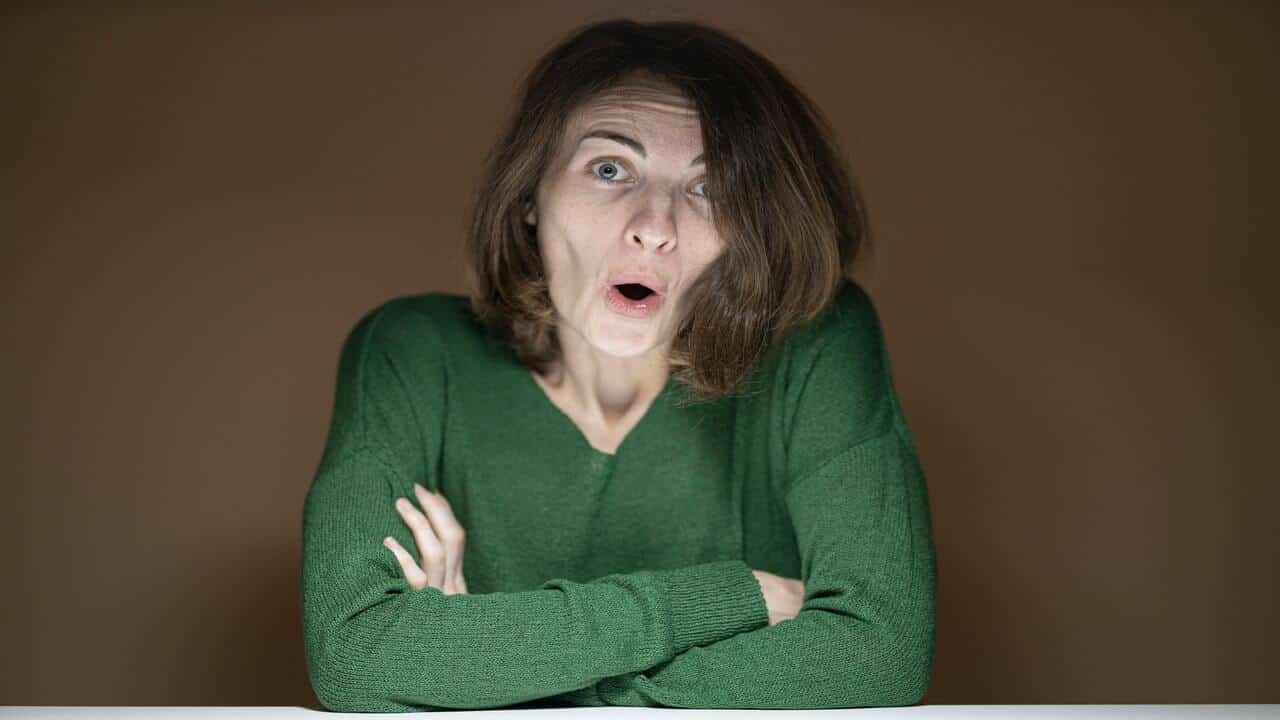 A woman exaggerating her reaction.