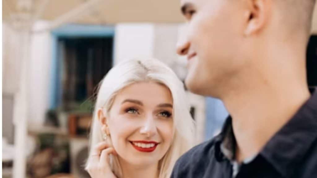 Woman smiling while complimenting a man’s outfit