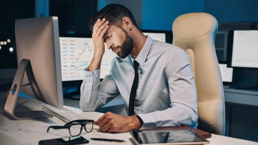 Man in the office looking exhausted