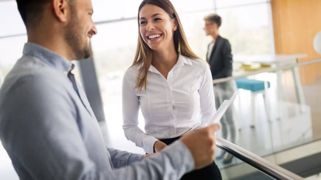 Woman nervously adjusting her outfit while talking to a man