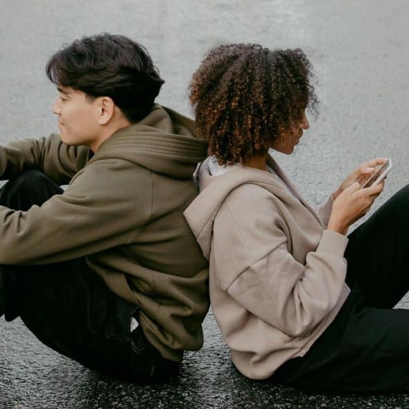 A man and woman using a phone