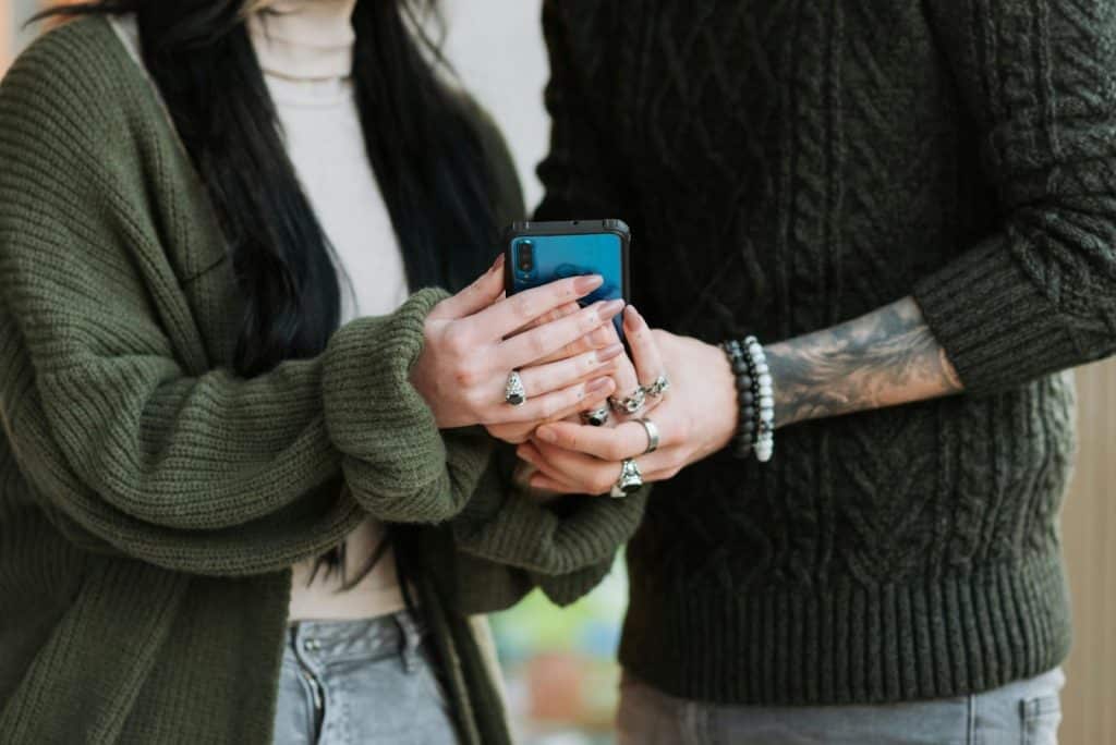 Two person sharing a phone