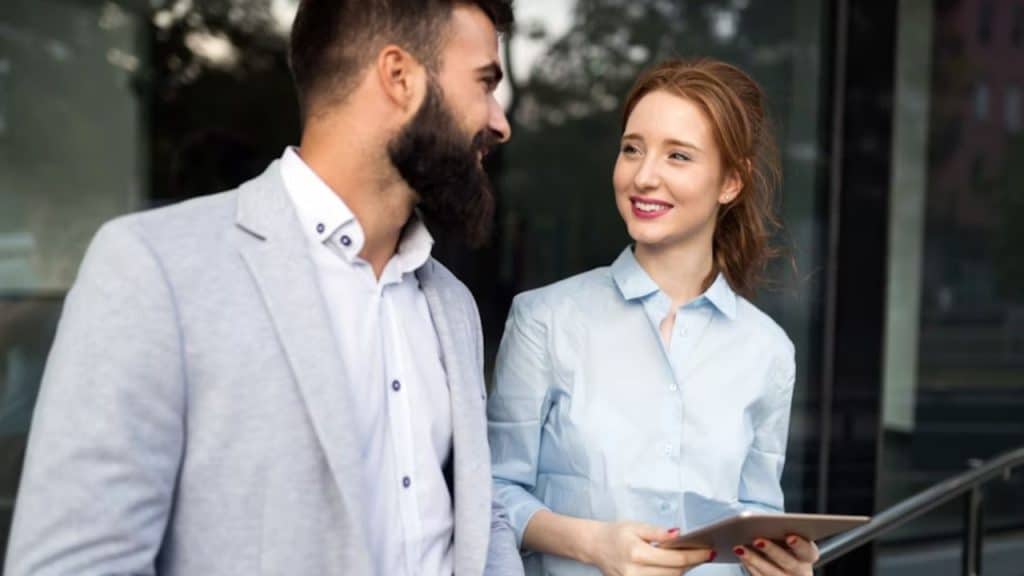 Woman lingering in conversation while holding her tablet