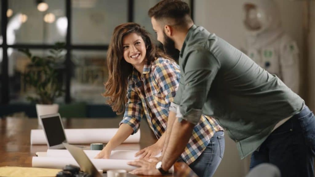 Woman biting her lip while glancing at a man